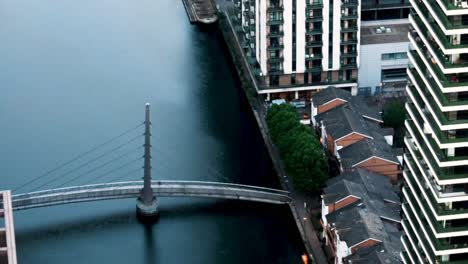 Rushing-across-the-bridge-into-Canary-Wharf,-London,-United-Kingdom