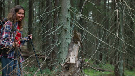 tourist walking in fairytale forest. happy woman hiking between trees in summer