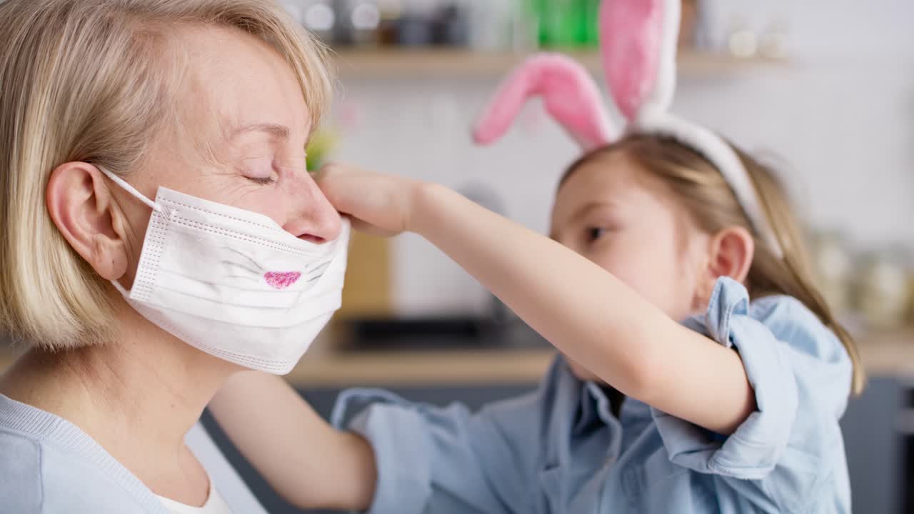 Video of a girl putting on a grandmother's mask