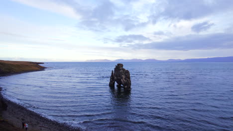 tourists visiting hvítserkur famous sea stack stone inn north iceland