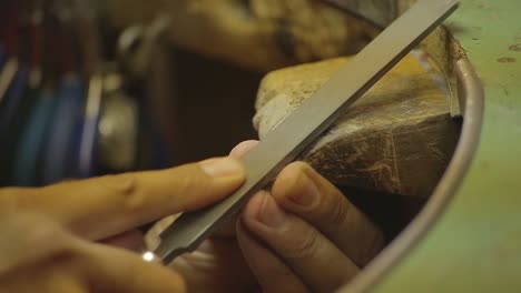 italian goldsmith at work building an engagement or a wedding ring