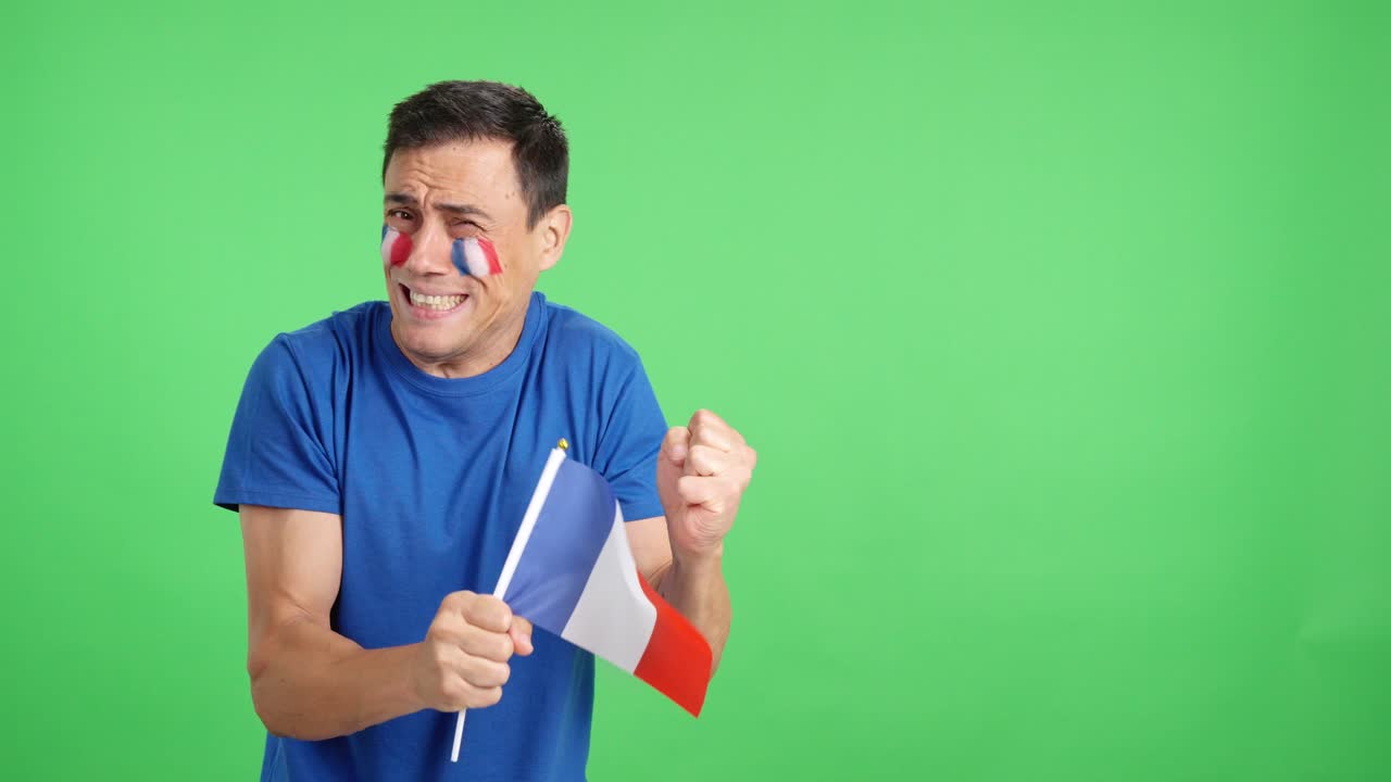 Nervous french supporter during an exciting match looking away