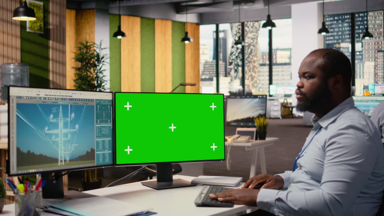 Technician Works On Power Line Tower Cad Design On Green Screen Pc In Office