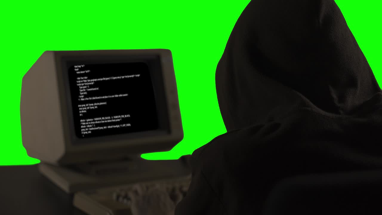 Hooded hacker stealing information from a computer