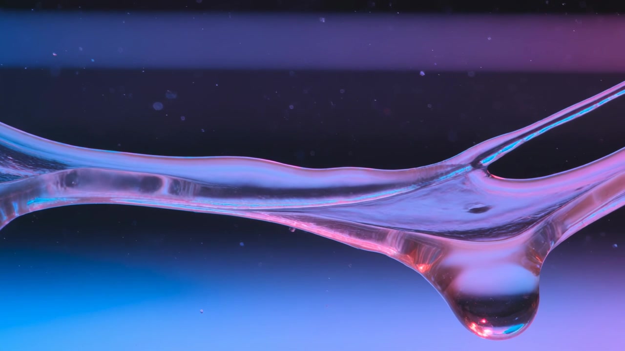 Necking liquid filament stretching in studio macro, droplet elongating, causing capillary breakup