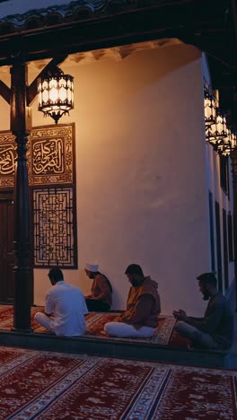 muslim men praying at a mosque at night