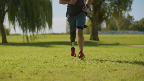 Middle-aged-athlete-with-leg-prosthesis-jogging-in-city-park.