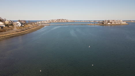 High-Aerial-flight-over-Hull-Bay,-MA-on-the-inside-of-the-Hull-peninsula