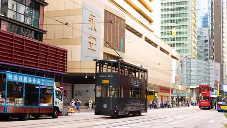 tram moves through busy hong kong street