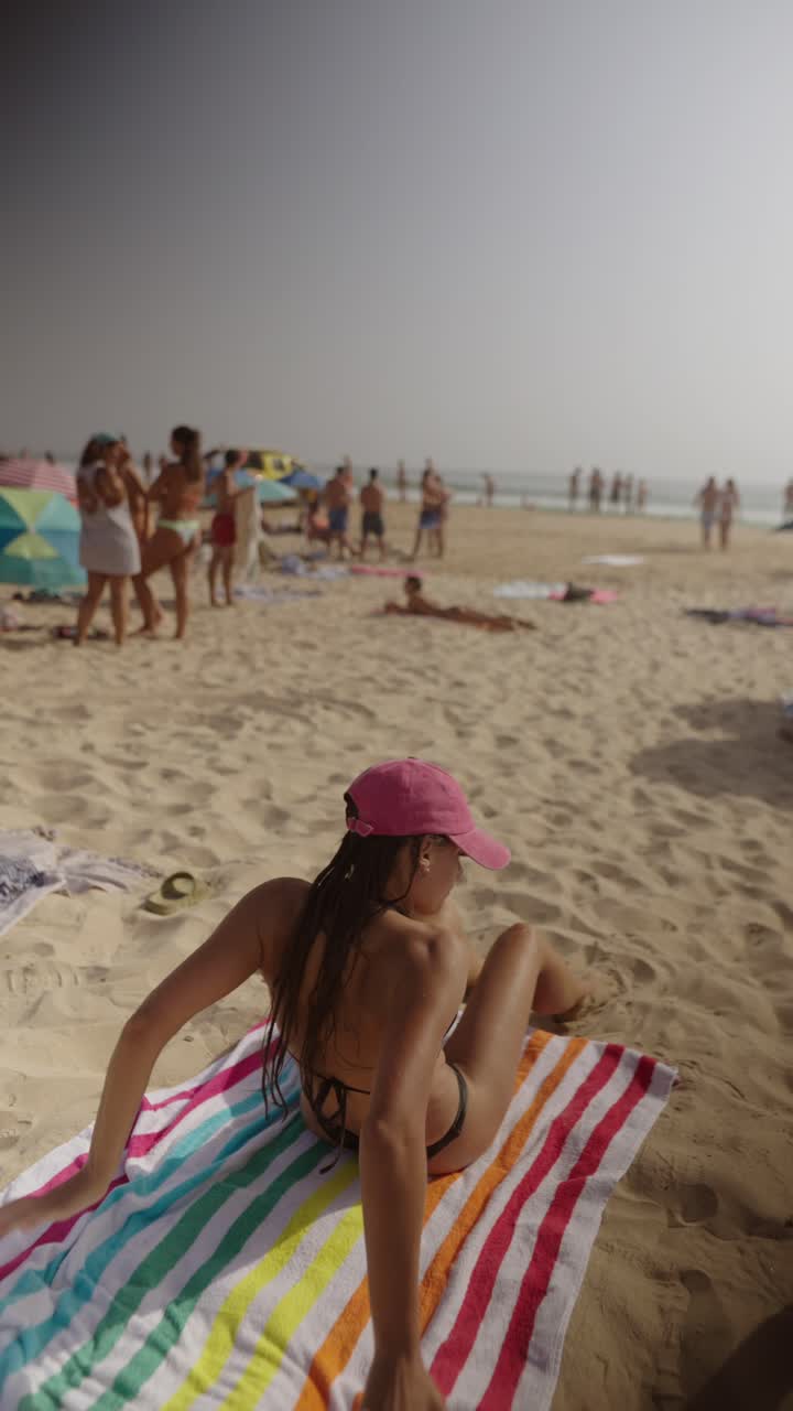 Woman in Pink Cap Relaxing on Beach