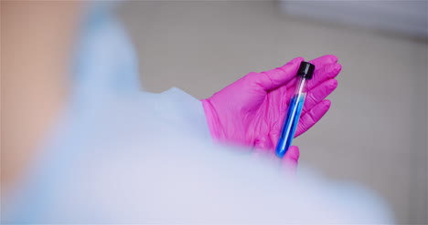 Working-In-Lab-Scientist-Holding-Test-Tubes-Positive-Test-Of-Covid-19-Coronavirus-At-Laboratory-6