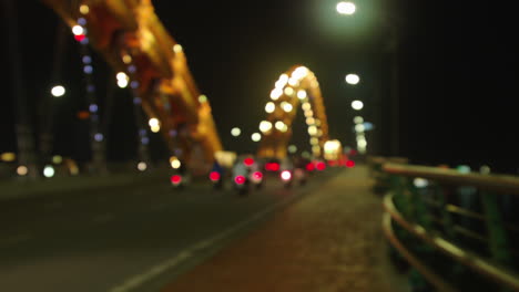 Bokeh-of-vehicles-crossing-through-Dragon-Bridge-in-Da-Nang-city-of-Vietnam-built-over-Han-river-at-night