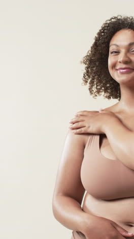 vertical video: embracing body positivity, smiling plus size woman posing confidently