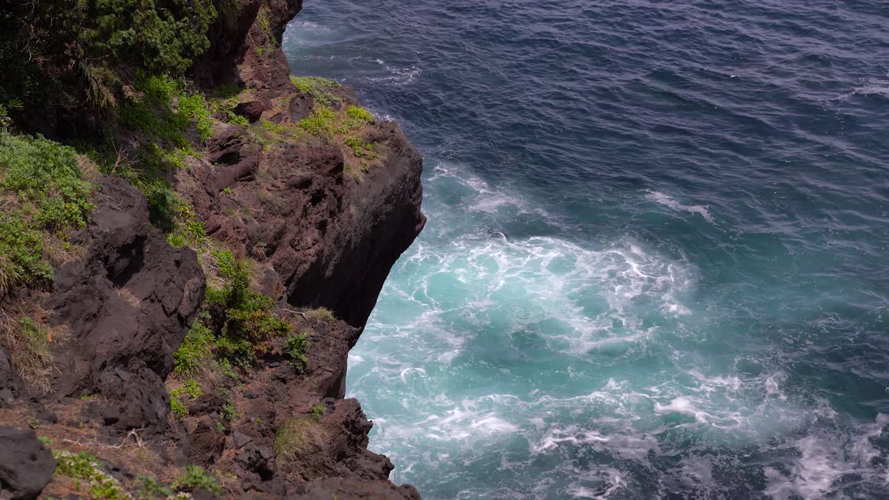 Tropical Ocean Waves Breaking On The Rocky Cliffs During Summer