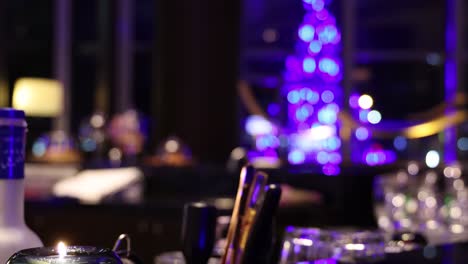 luxurious restaurant table setup with glowing christmas tree