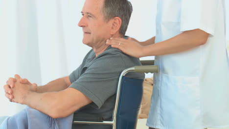 man in a wheelchair listening to