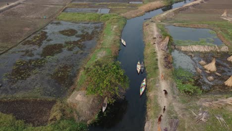 Drone-video-of-soil-road,-rivers-and-canals-in-East-Asia-villages