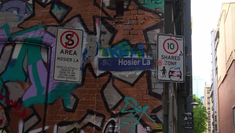 hosier lane in melbourne city, a renowned laneway showcasing a vibrant array of art murals and graffiti adorning the exterior walls of buildings, popular famous laneway for street art.