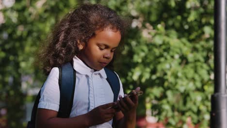 young student using smartphone outdoors