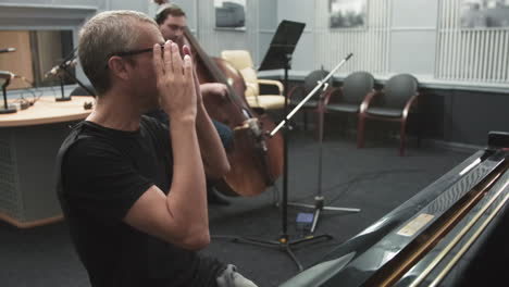 Jazz Musicians Playing In Live Room At Recording Studio