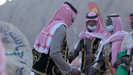 traditional arab men performing dances and music at the dakar rally