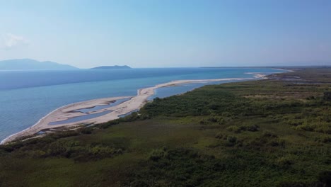ascending aerial view over river estuary and vast coastline, nestos river, greece