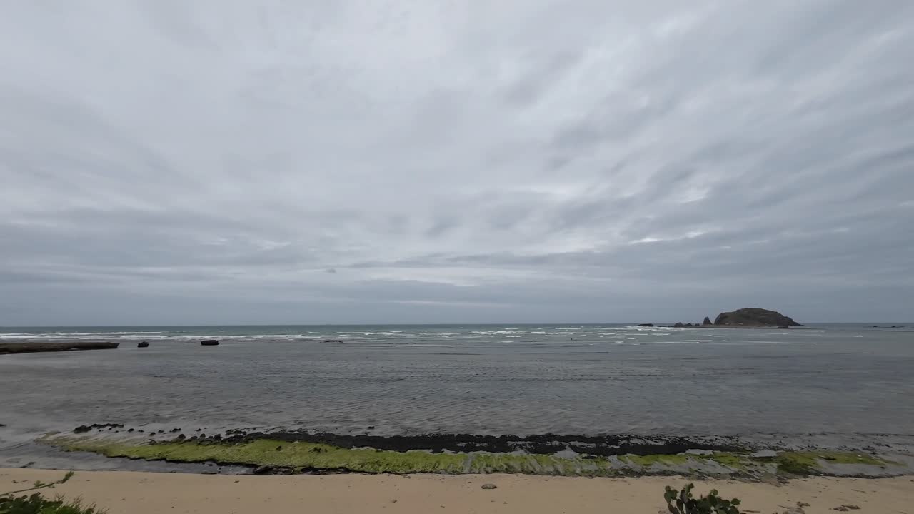 Wide panoramic view of My Hoa Lagoon in Vietnam on a cloudy day, showing calm shallow sea, sandy coastline and peaceful tropical atmosphere, ideal coastal scenery for travel and nature concepts