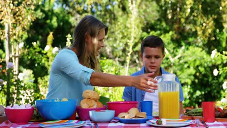 Mother-interacting-with-her-son-while-having-meal