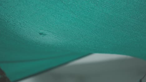 water droplets forming at the surface of green shade net