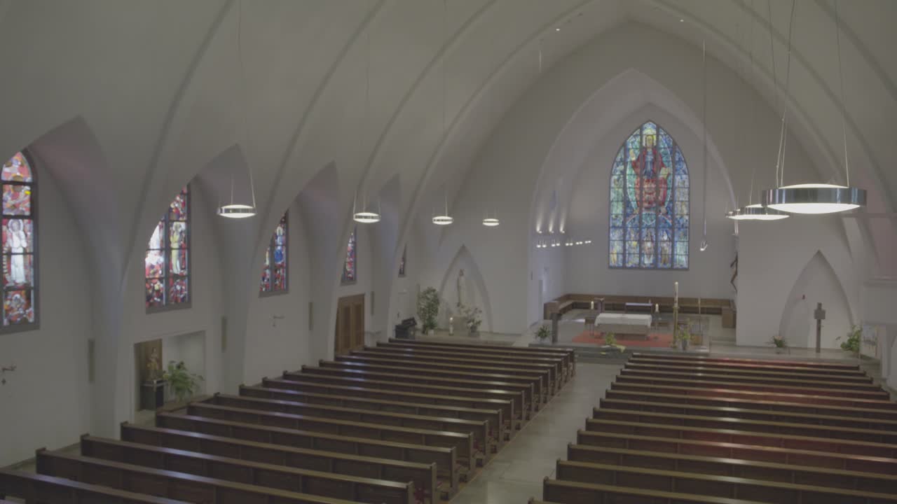 Camera pans to the chancel of the empty church of St. Konrad and Elisabeth in Freiburg, Germany