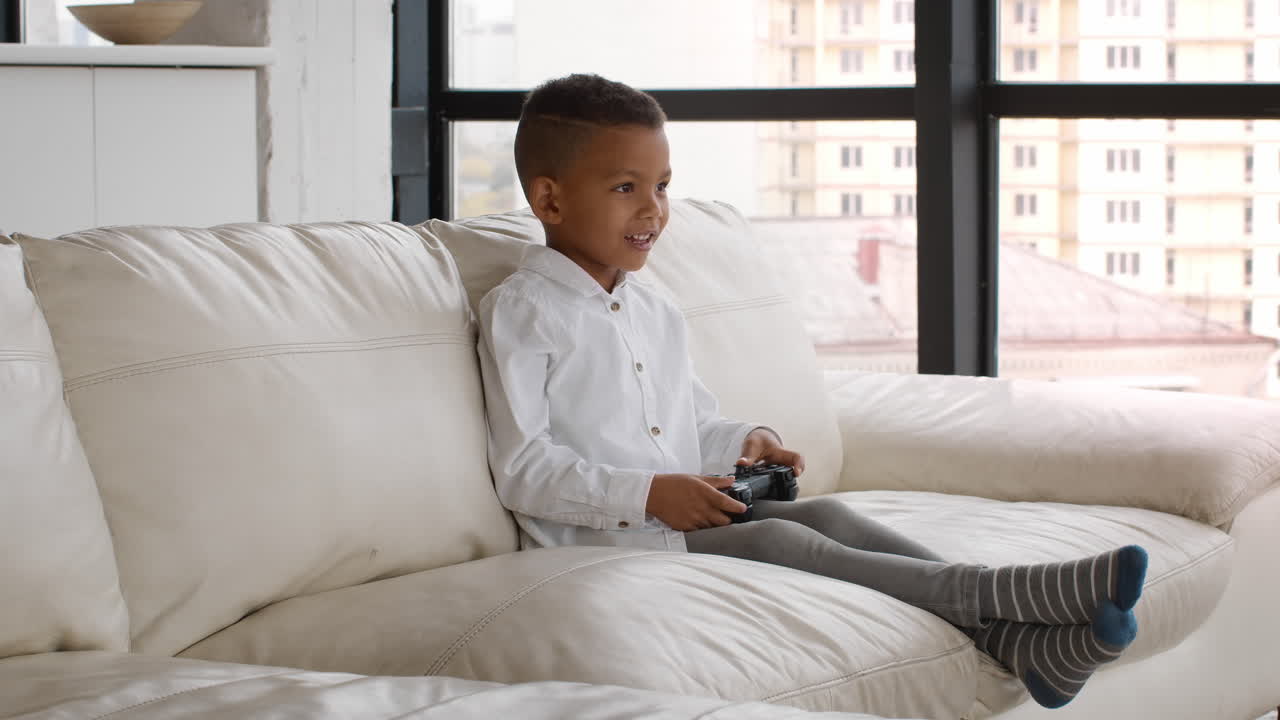 A child playing video games on a couch