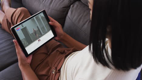 composite of woman sitting at home on couch watching athletics running event on tablet