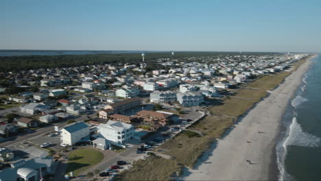 establishing aerial view panning over kure beach property and seaside view