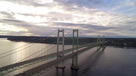 rising wide drone shot of tacoma narrows bridge at sunrise, circa 2015