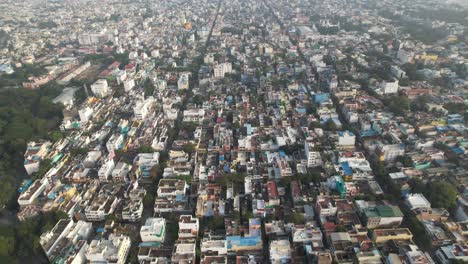 aerial drone shot of crowded buildings in indian city during sunset