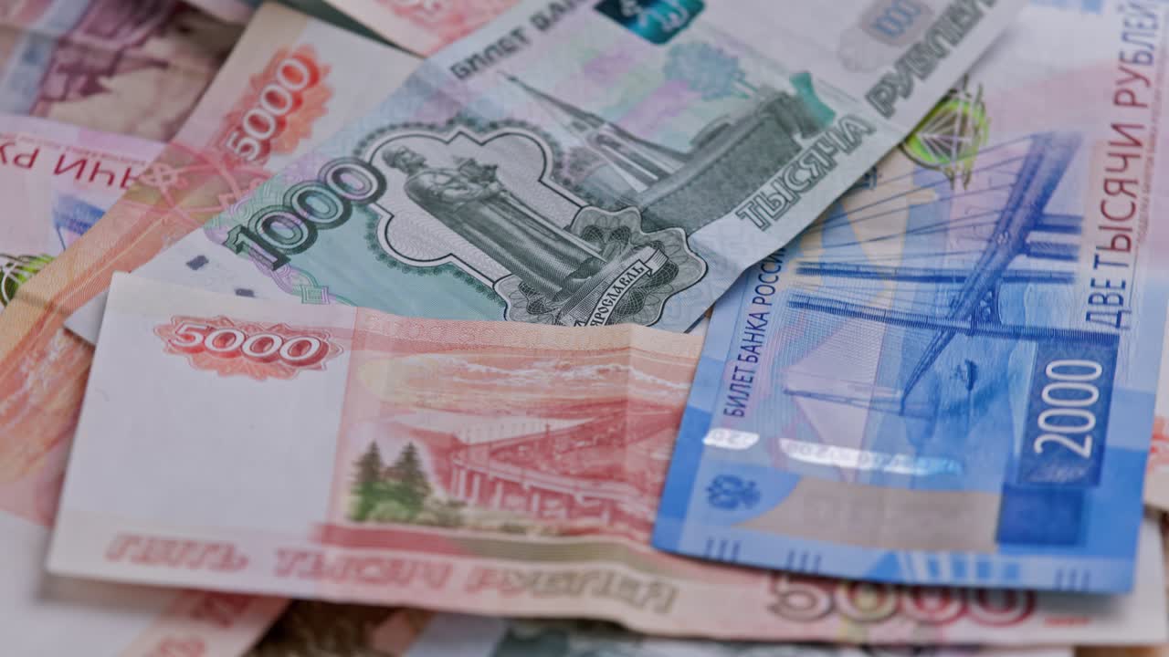 Looped rotation of Russian rubles paper banknotes of different dignity.