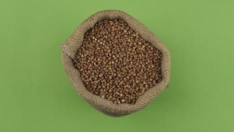 rotation of a full sack of buckwheat grain. top view. isolated