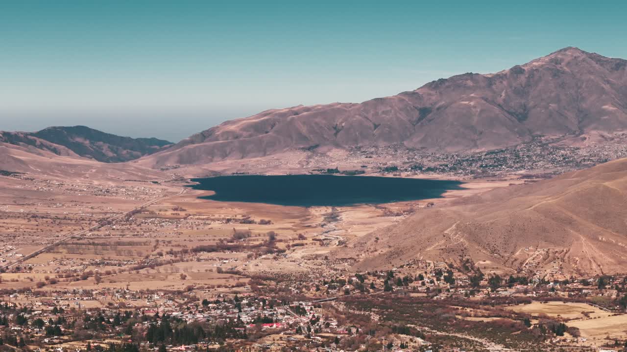 Lateral drone image of Tafí del Valle and El Mollar, featuring the grand La Angostura dam at the center