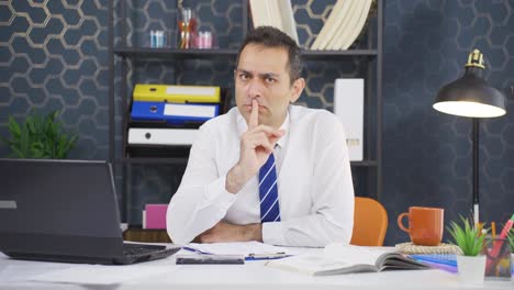 businessman telling camera to shut up.