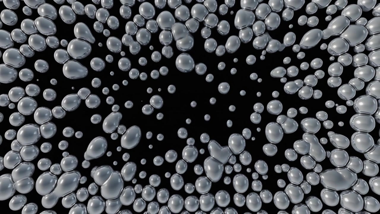 Abstract Animation of Growing Metallic Spheres on Black Background