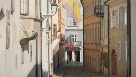 traditional historic streets in bratislava with national flags on buildings