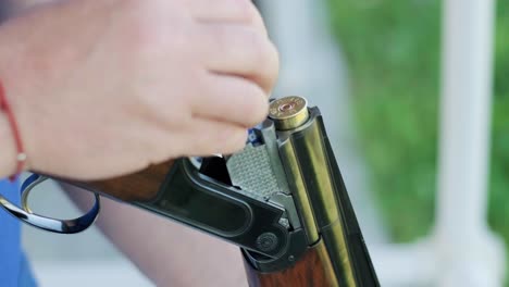 sportsman shoots from a double-barreled shotgun, a sports field for a shooting test is shooting at flying skeet