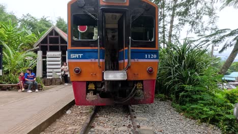 train arrives at a rural thai station