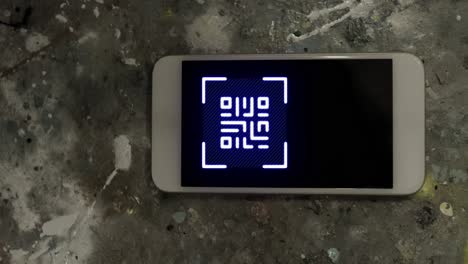 animation of gr code over smartphone lying on grey surface