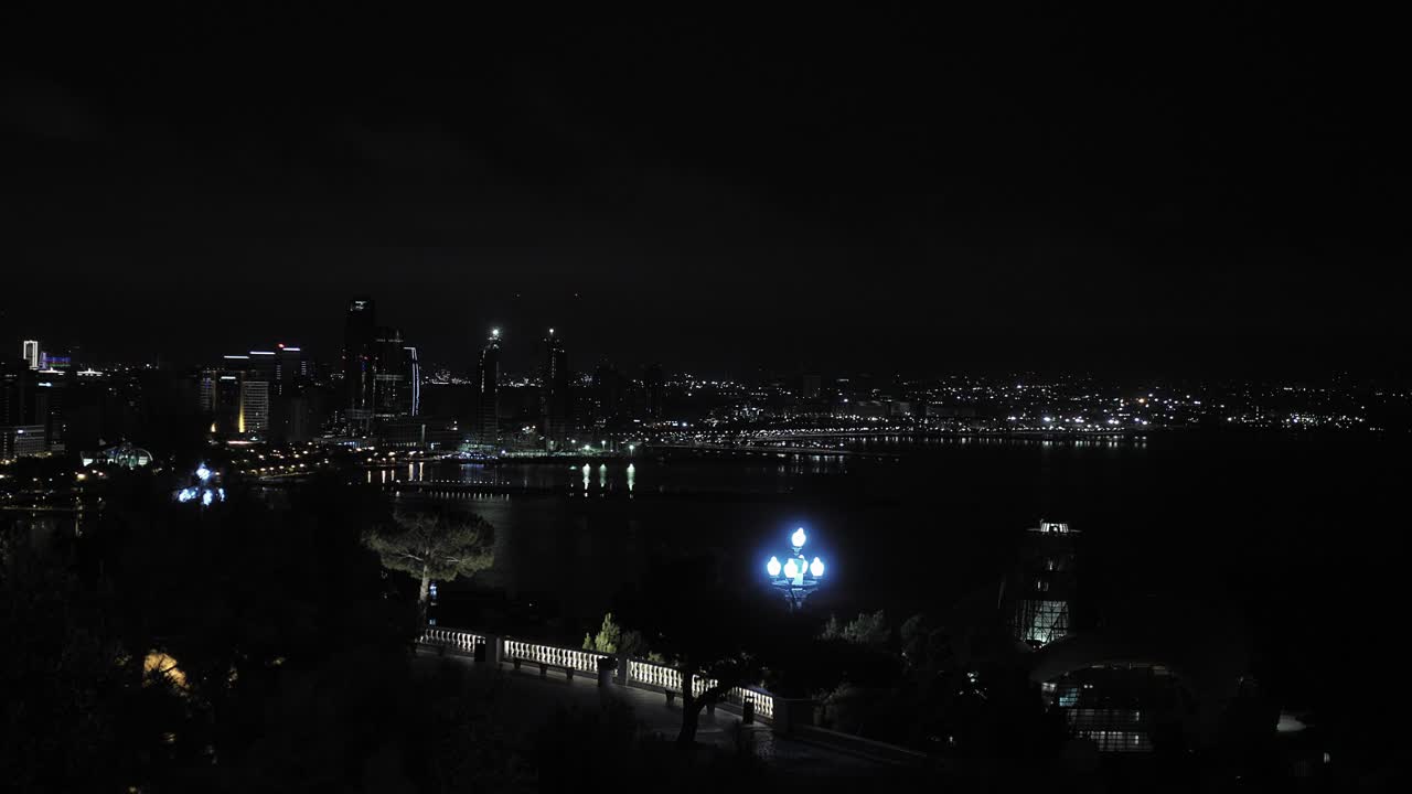 Coastal city at night creating a beautiful picturesque panorama view of the port and the sea in Baku Azerbeijan.