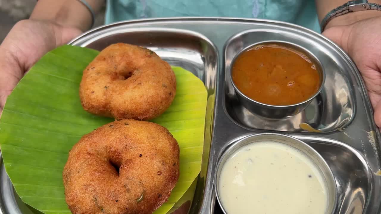 Masala Vada, a popular street food of South Indian cuisine served with chutney and sambhar.