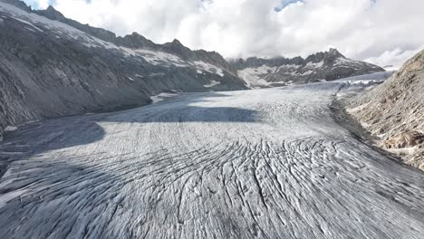 aerial view of the rhône glacier, captured by a drone on a cloudy day