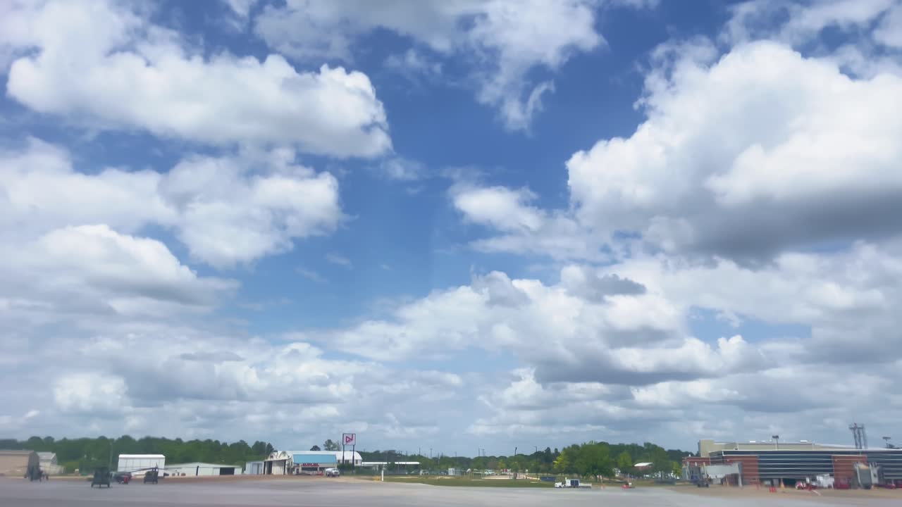 Beautiful Blue Sky with Fluffy White Clouds over an Airport