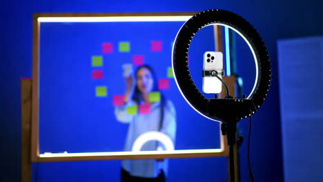 sticky note brainstorming. a person brainstorms with sticky notes on a board as a phone captures the moment