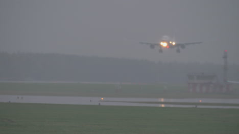 the plane landing on a rainy evening